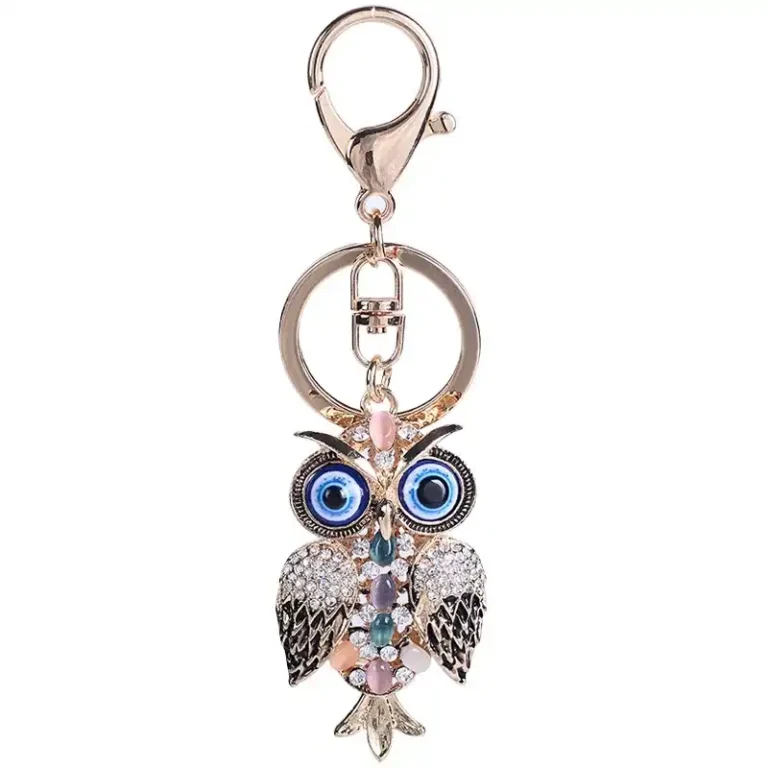 Owl keychain with large blue eyes, clear rhinestones, pastel-colored stones, a split ring and lobster clasp
