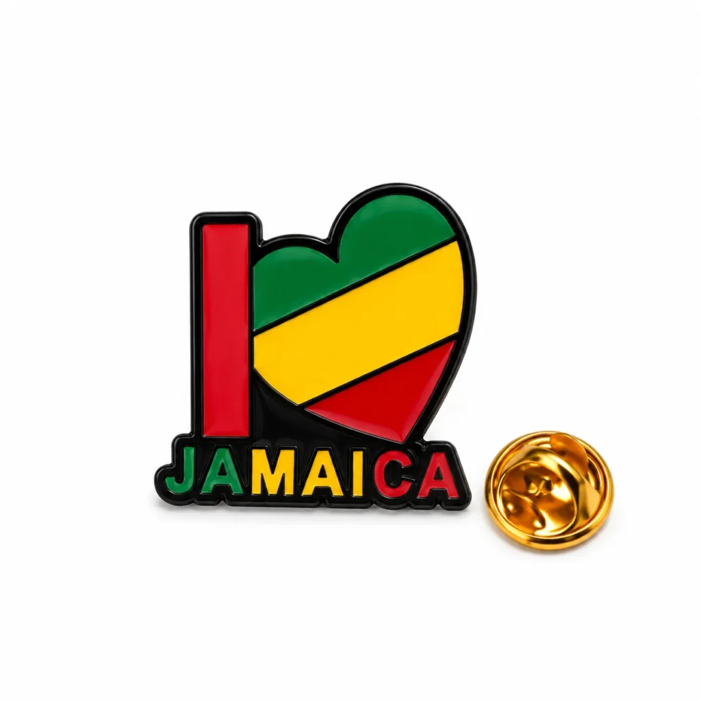 I Love Jamaica enamel pin with a green, yellow and red heart and separate butterfly clasp on a white background