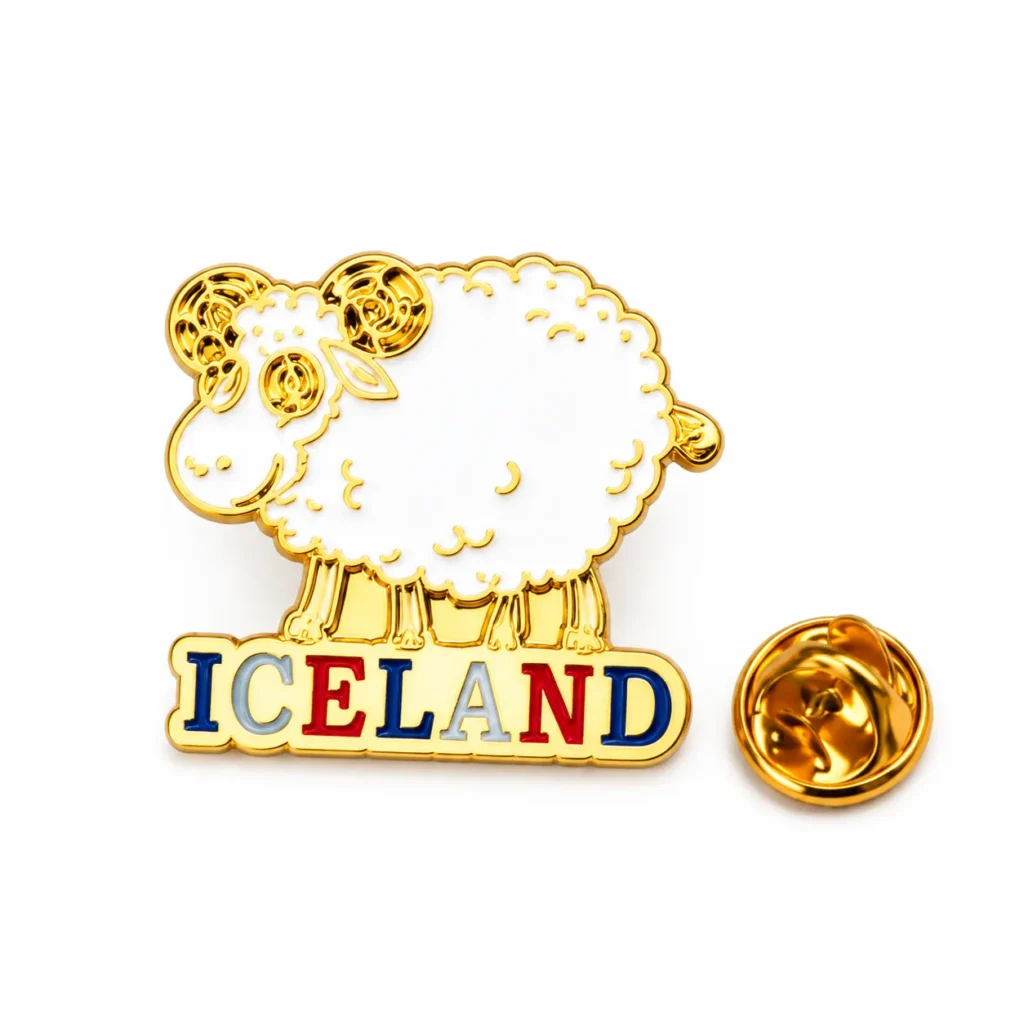 White Iceland sheep enamel pin with curled horns, colorful ICELAND lettering and gold-tone butterfly clasp