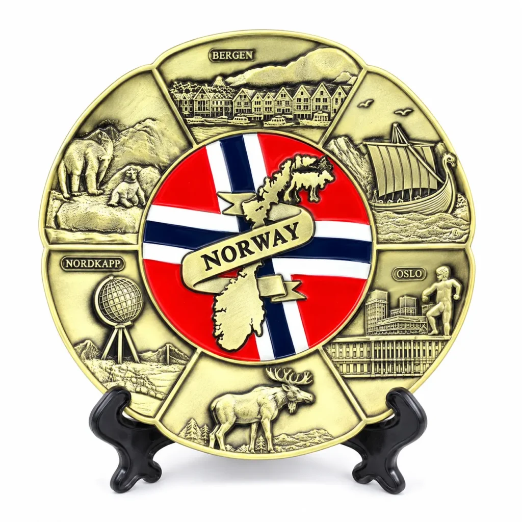 Brass-tone Norway souvenir plate with Norwegian flag, map, Viking ship and moose relief on a black stand
