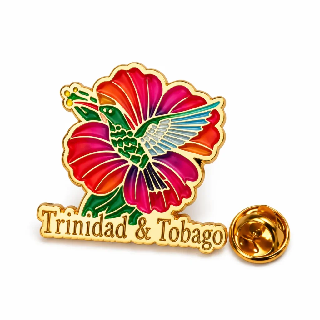 Trinidad and Tobago enamel pin with a green hummingbird over a colorful flower and gold-tone butterfly clasp