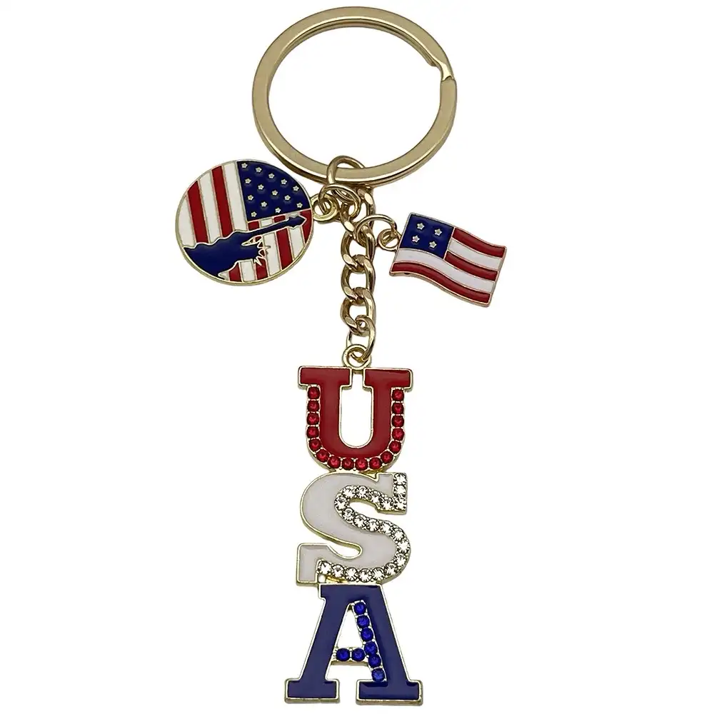 Gold-tone USA letter keychain with red, white and blue rhinestone accents, flag charms and Statue of Liberty detail